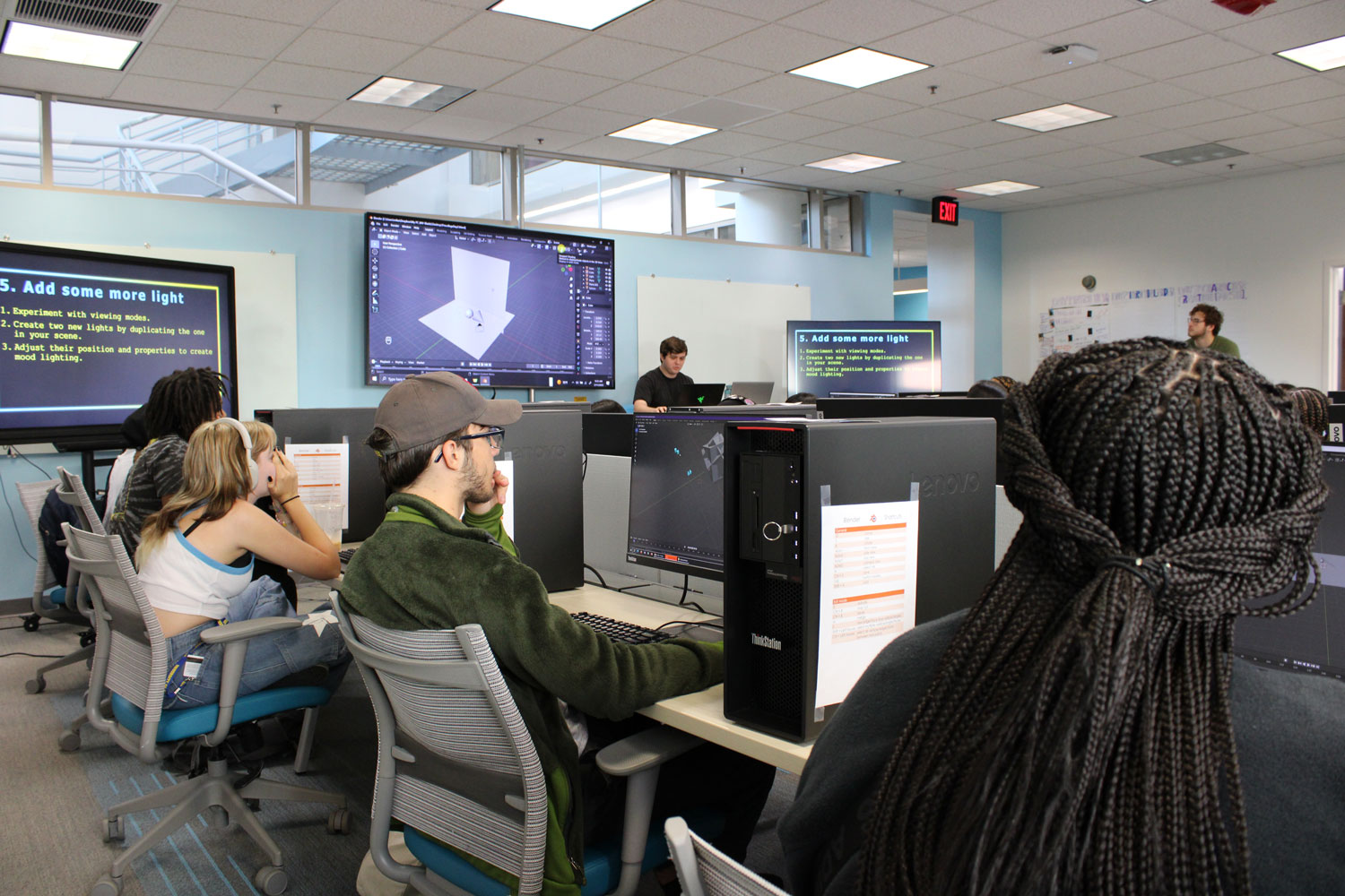 Miles teaches Unity to a room full of students working on computers.