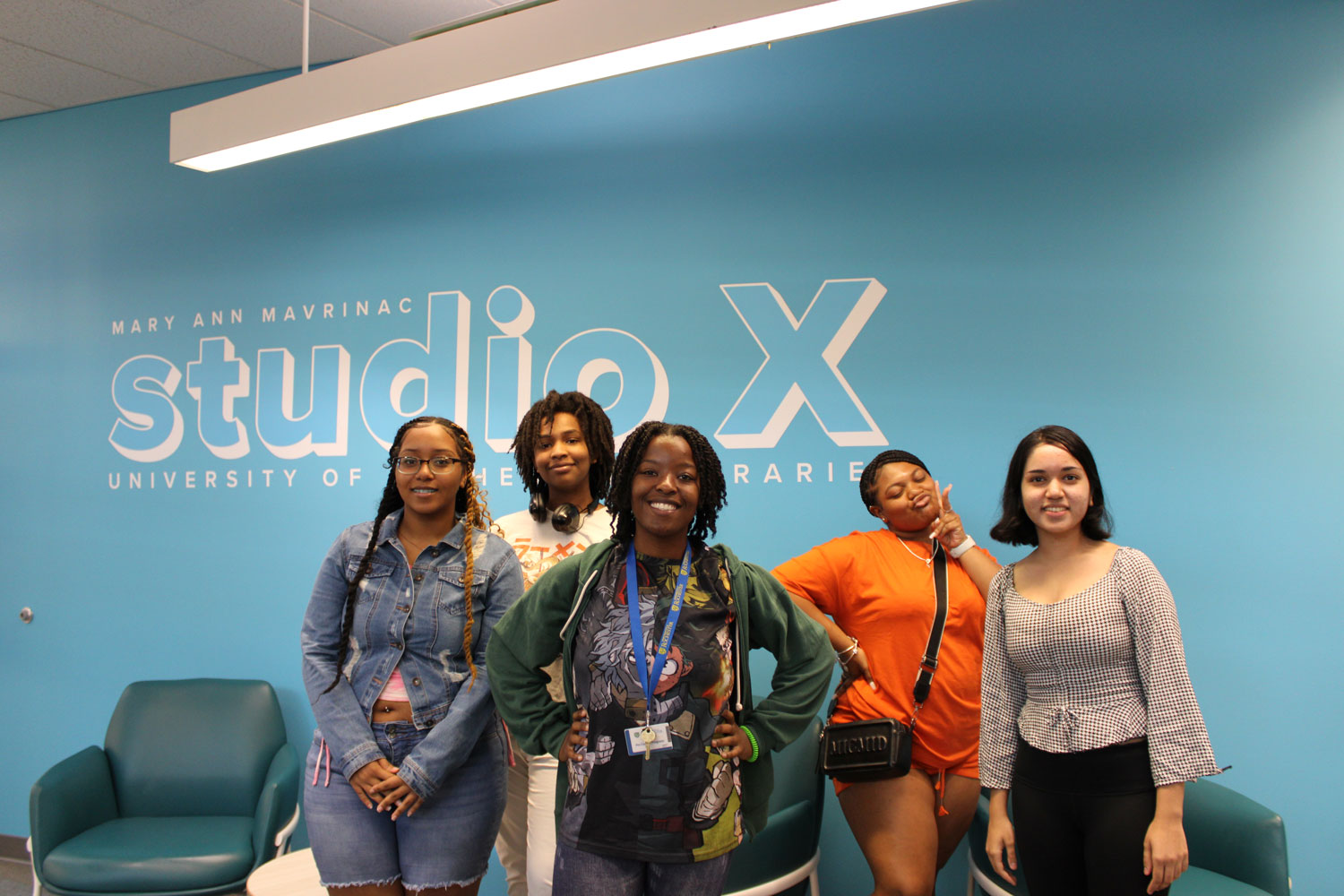 Pre-College students pose in front of the Studio X sign to celebrate their projects being named 'best in class' by their peers.