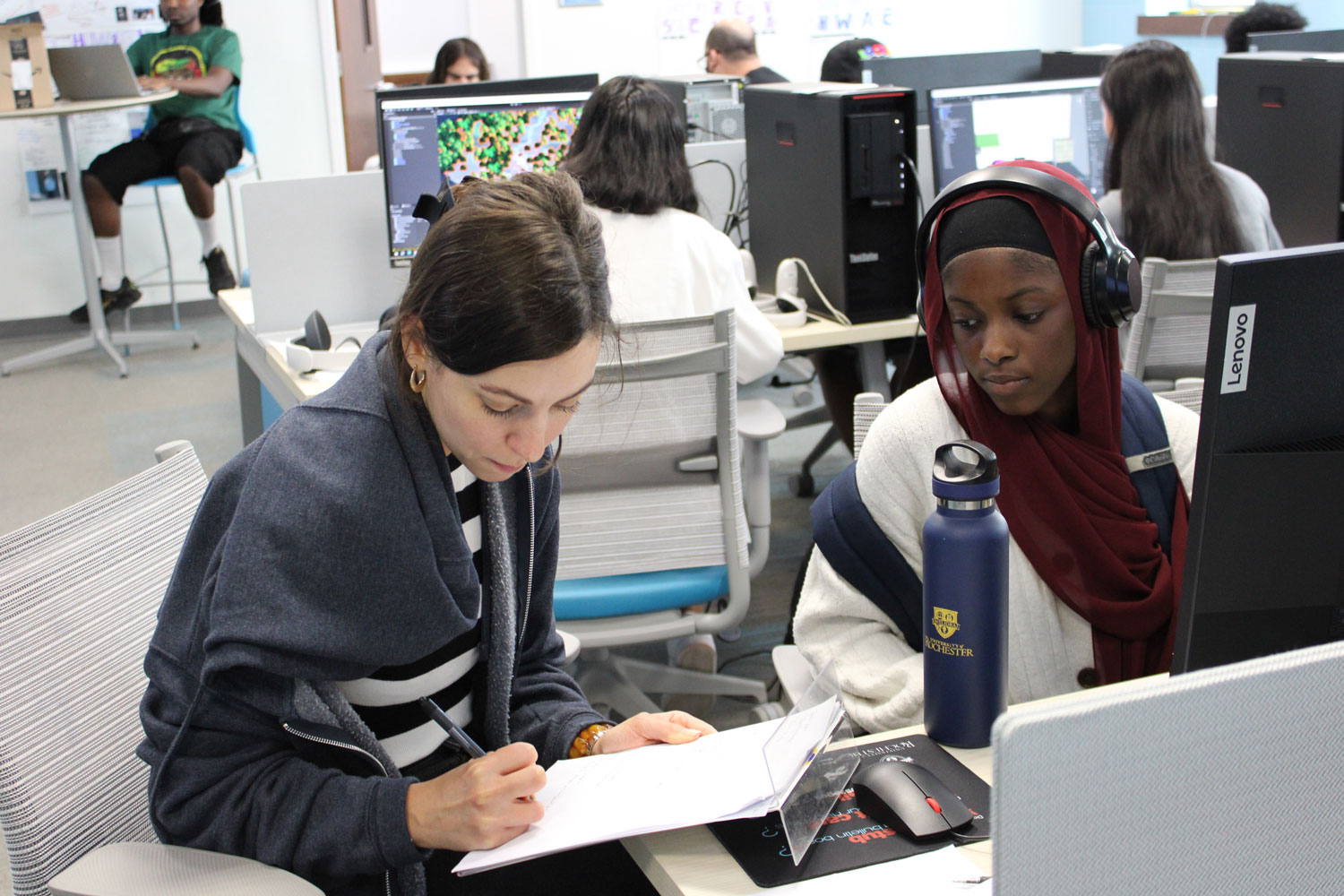 Meg works with a student on their project.