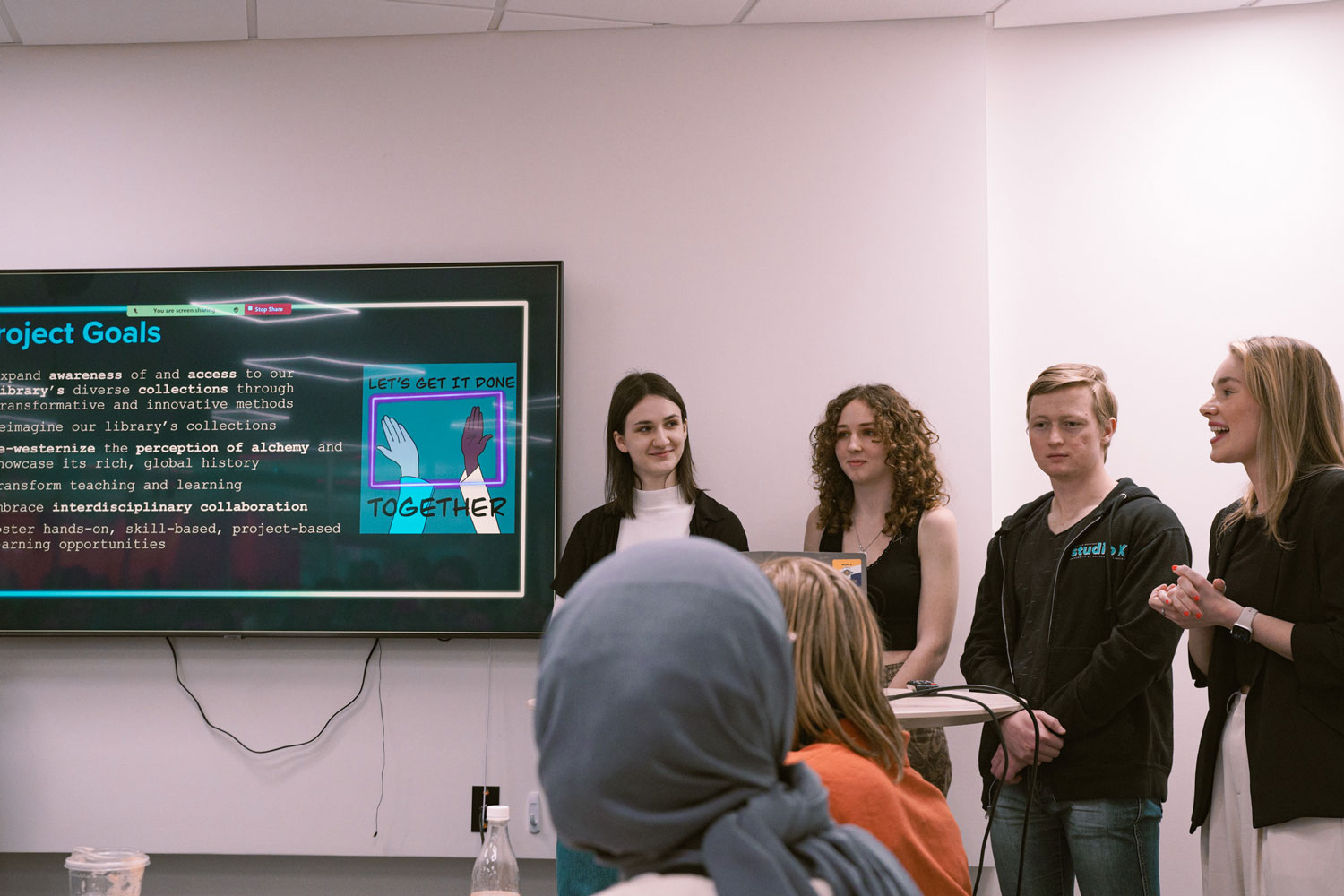 Liz, Libby, Sam, and Mila present on the Aurum project at the Student Showcase.