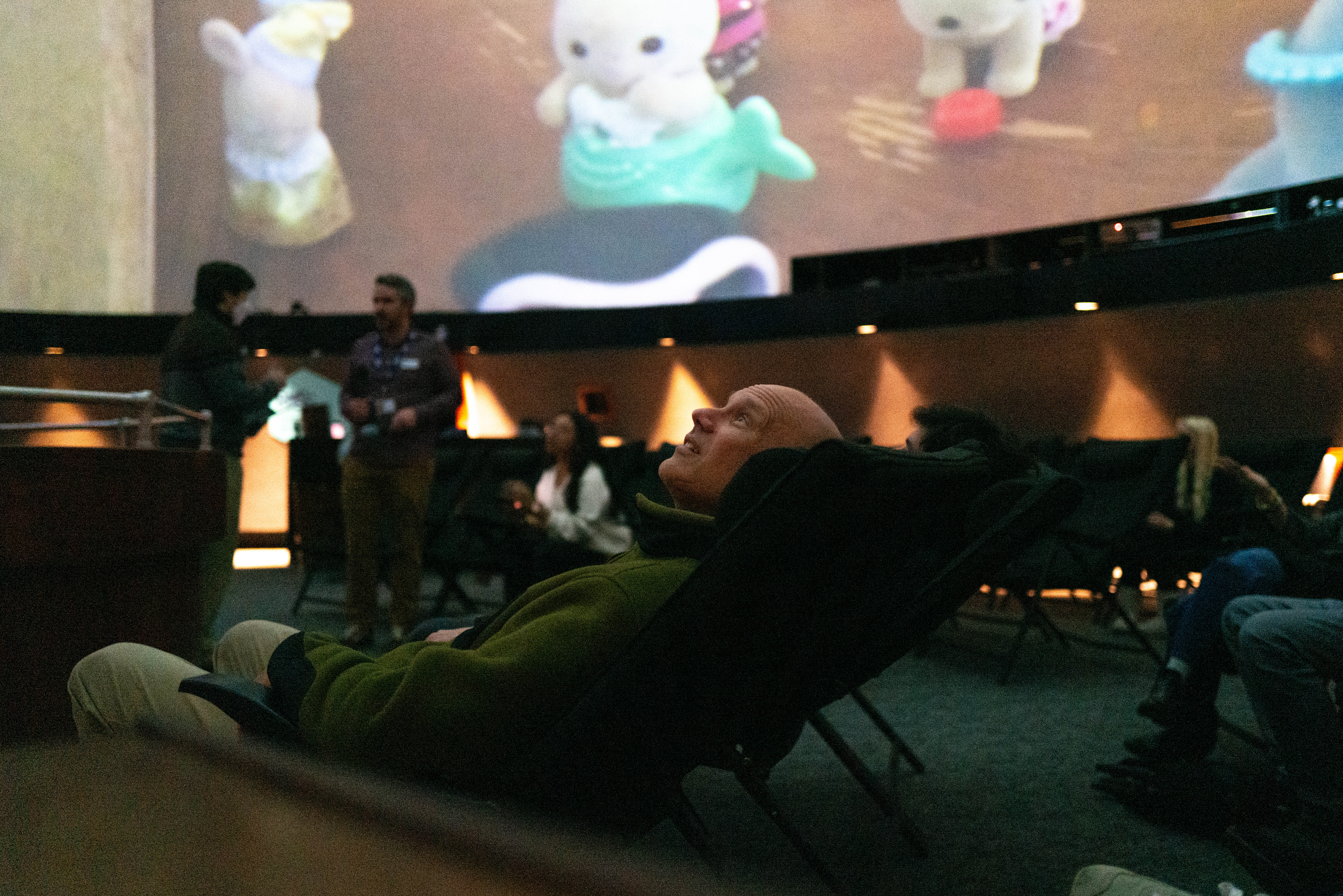 Person looking up at immersive film screen.