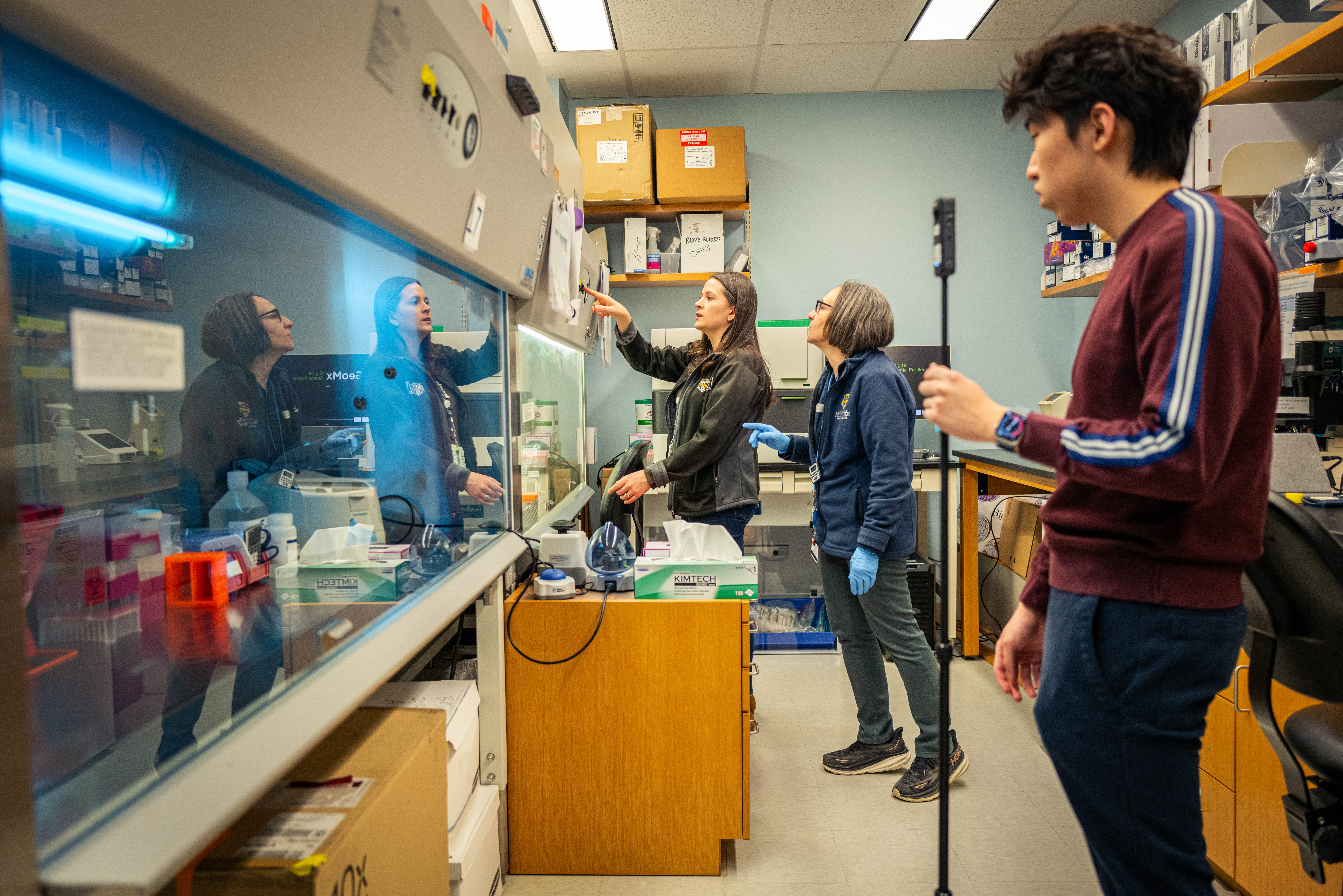 Videographer and two people in perception lab.