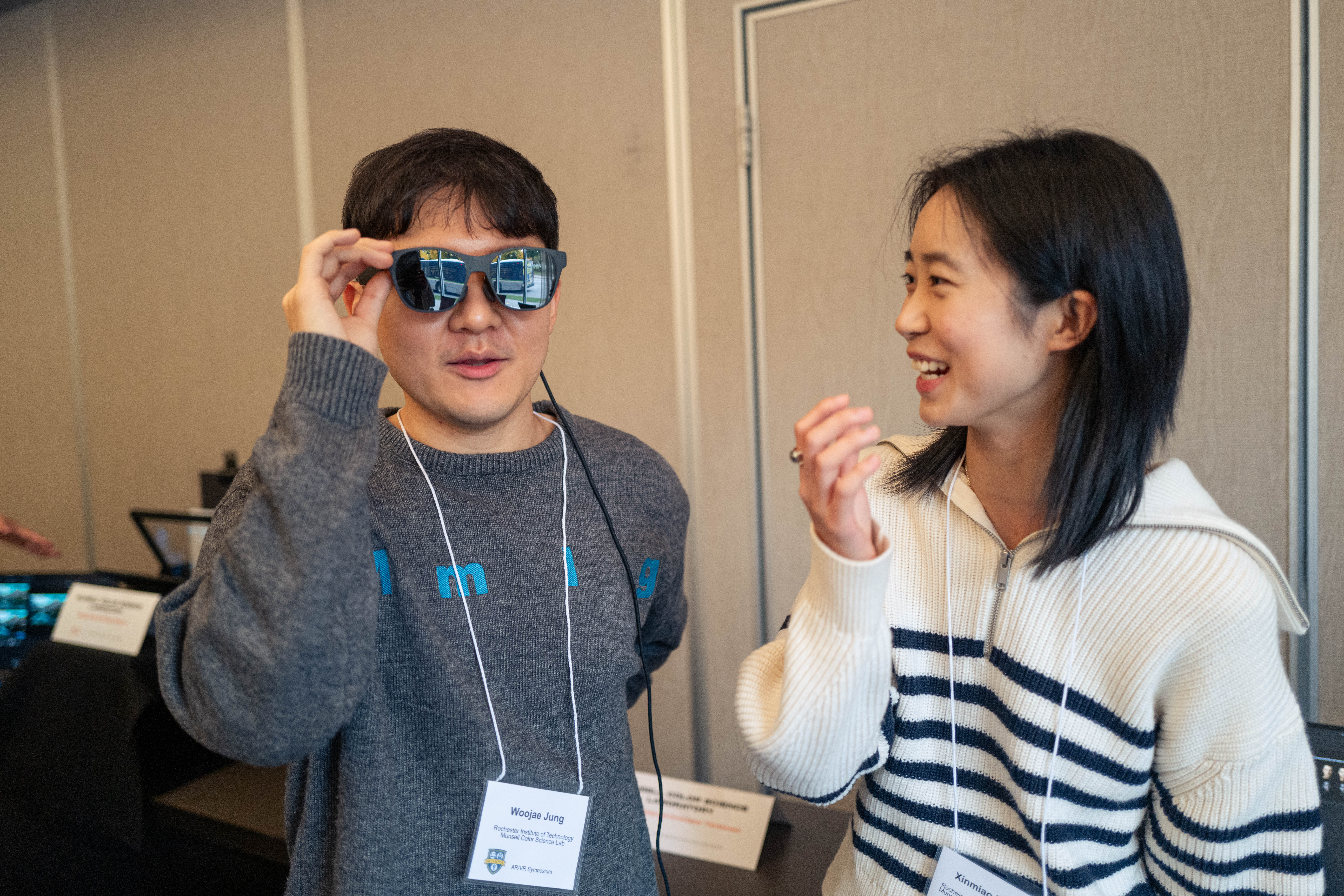 Two students smile at the AR/VR symposium.