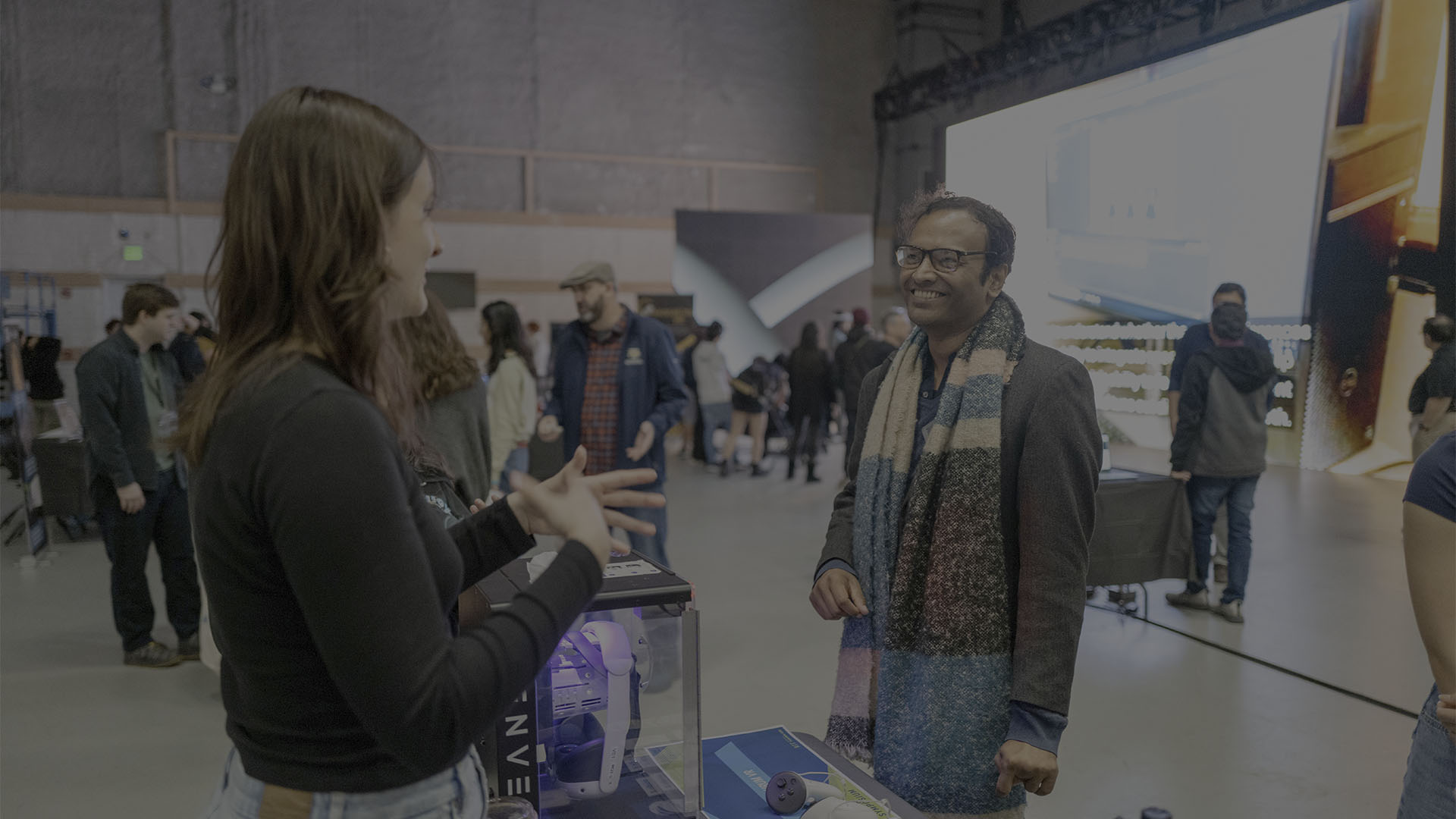 Student presenting Aurum to patron at XR showcase event.