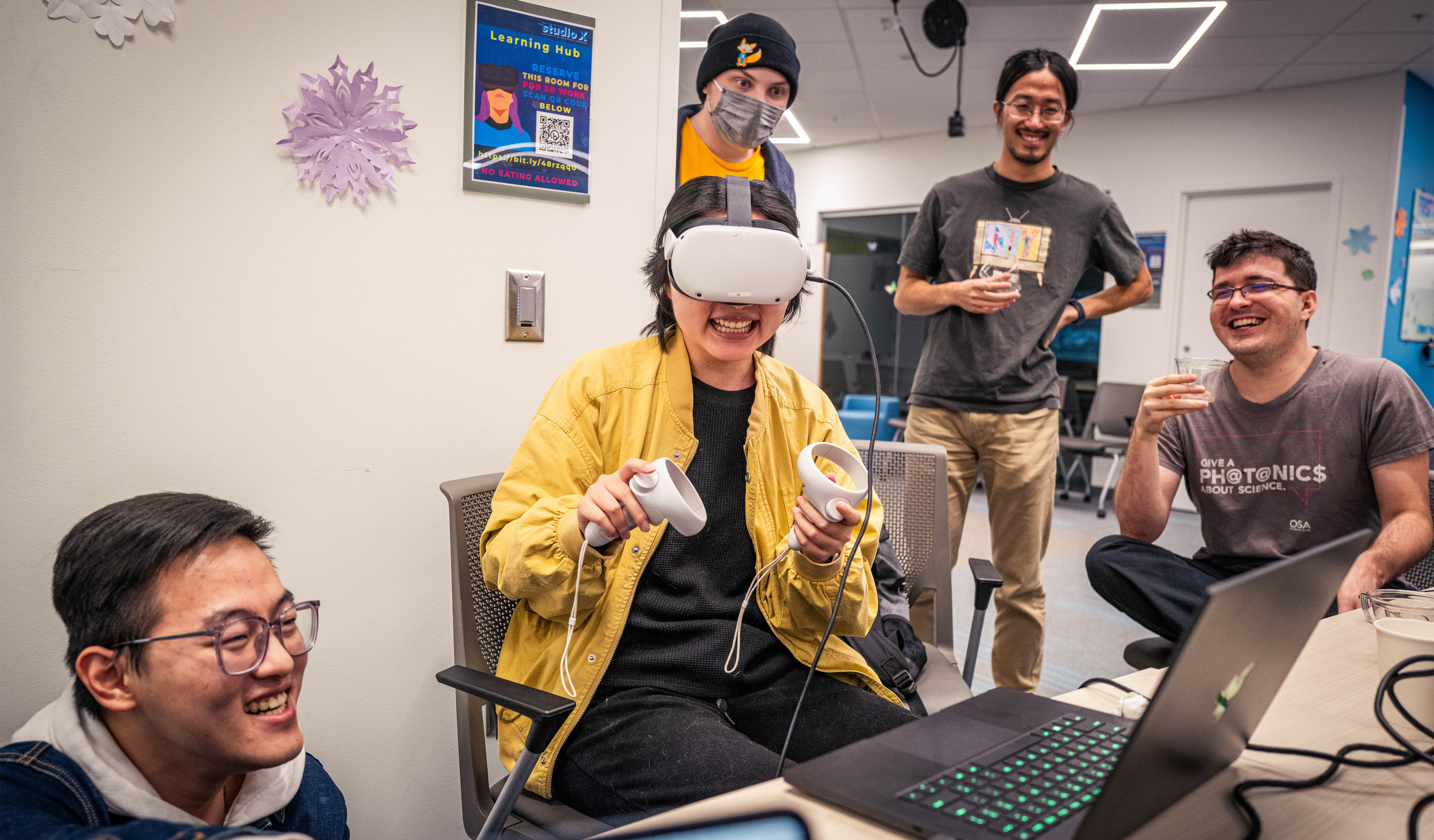 4 students learning and laughing with Metaquest headset.